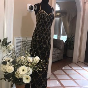 Black silk gown with gold beads and sequins.